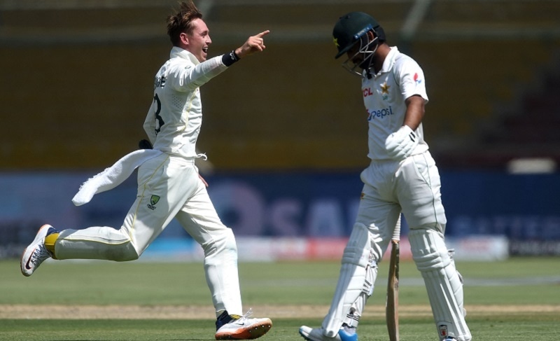 Australia's Marnus Labuschagne (L) celebrates after the dismissal of Pakistan's Abdullah Shafique (R) during the third day of the second Test match between Pakistan and Australia at the National Cricket Stadium in Karachi on Monday. — AFP