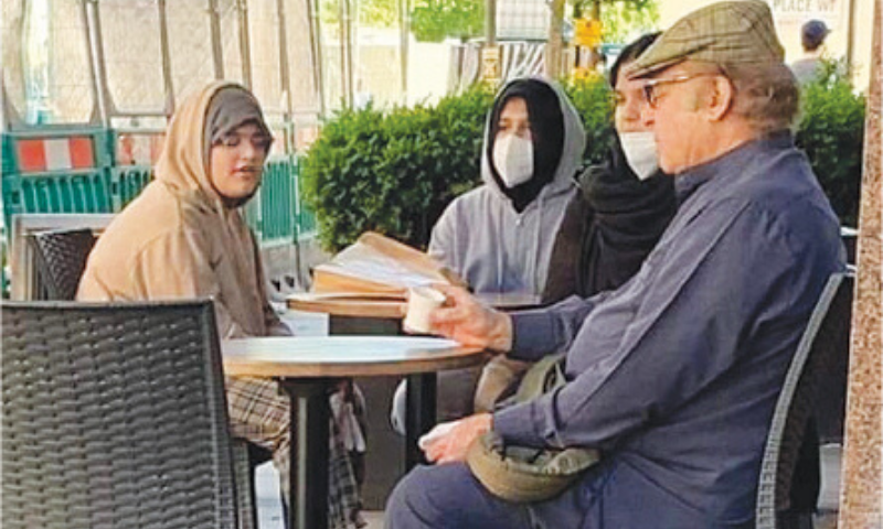 This May 2020 file photo that went viral on social media appears to show former prime minister Nawaz Sharif sitting with his granddaughters at a roadside cafe in London. — Source: Twitter/File