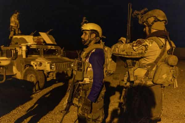 Members of the Afghan Special Forces get ready before a combat mission against Taliban, in Kandahar province, Afghanistan, 11 July.