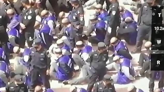 The blindfolded and shackled detainees are from China's minority Uighur Muslims, according to a source. Video was posted anonymously on Twitter and YouTube