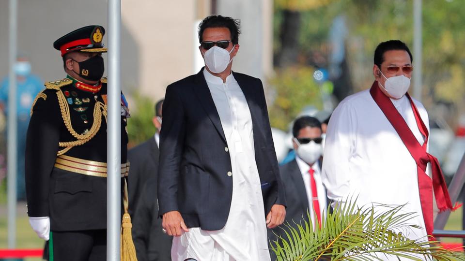 Pakistan Prime Minister Imran Khan, center, stands with Sri Lankan Prime Minister Mahinda Rajapaksa, right, after his arrival in Colombo, Sri Lanka, Tuesday, Feb. 23, 2021.