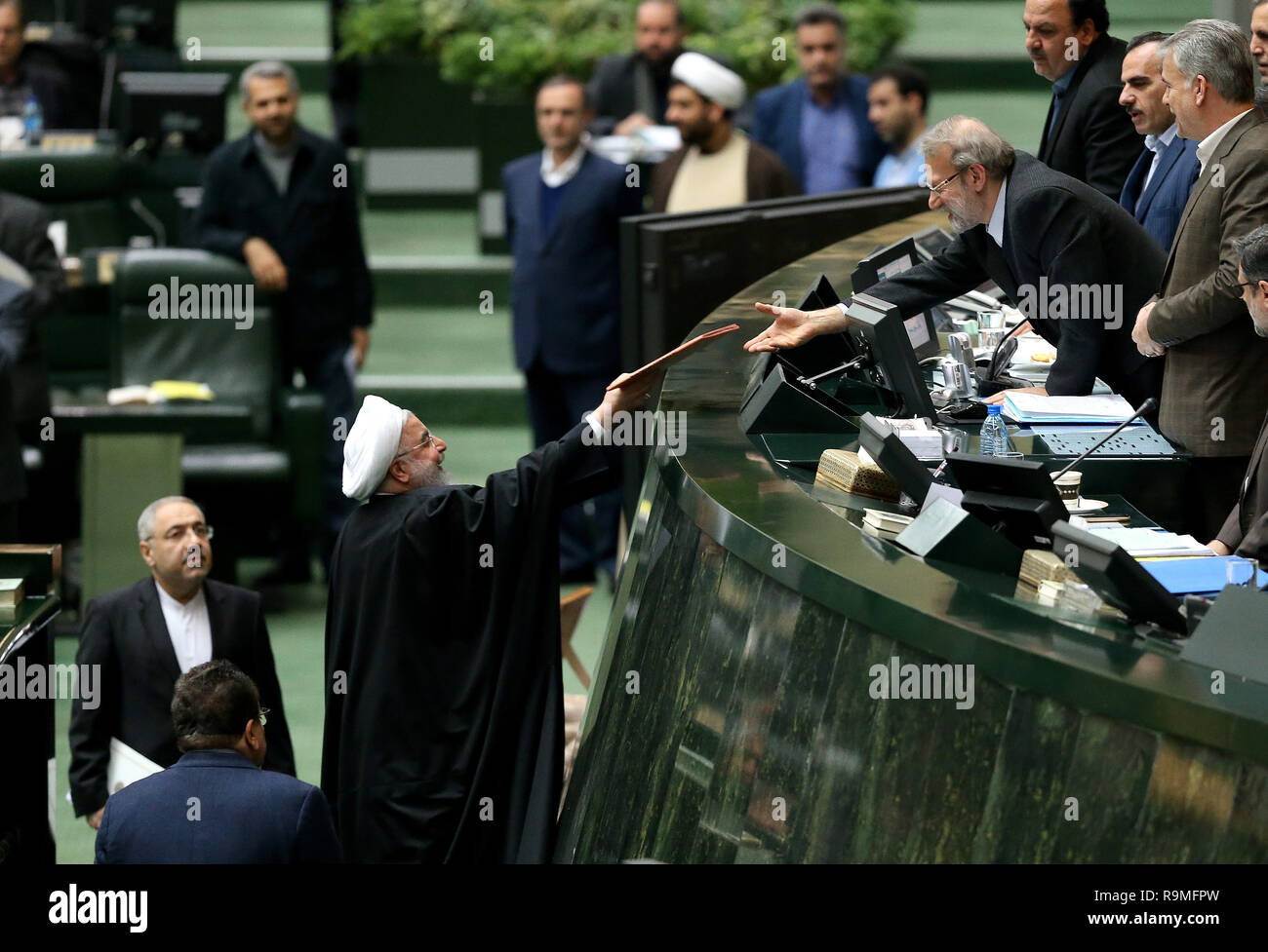 tehran-iran-25th-dec-2018-iranian-president-hassan-rouhani-submits-a-budget-bill-to-iranian-parliament-speaker-ali-larijani-during-a-session-at-the-parliament-in-tehran-iran-on-dec-25-2018-rouhani-said-on-tuesday-that-the-us-oppressive-sanction-pressures-against-iran-wont-achieve-their-ends-credit-ahmad-halabisazxinhuaalamy-live-news-R9MFPW.jpg