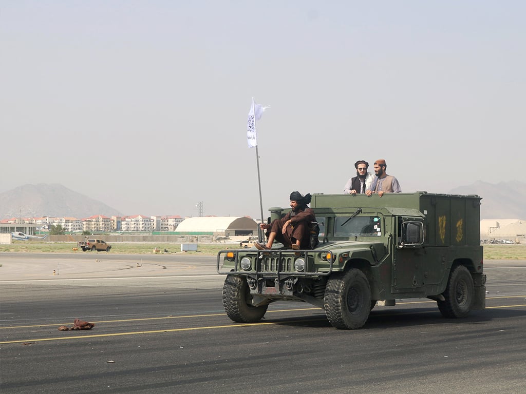 Taliban forces patrol at a runway a day after the U.S. troops withdrawal from Hamid Karzai international airport n Kabul