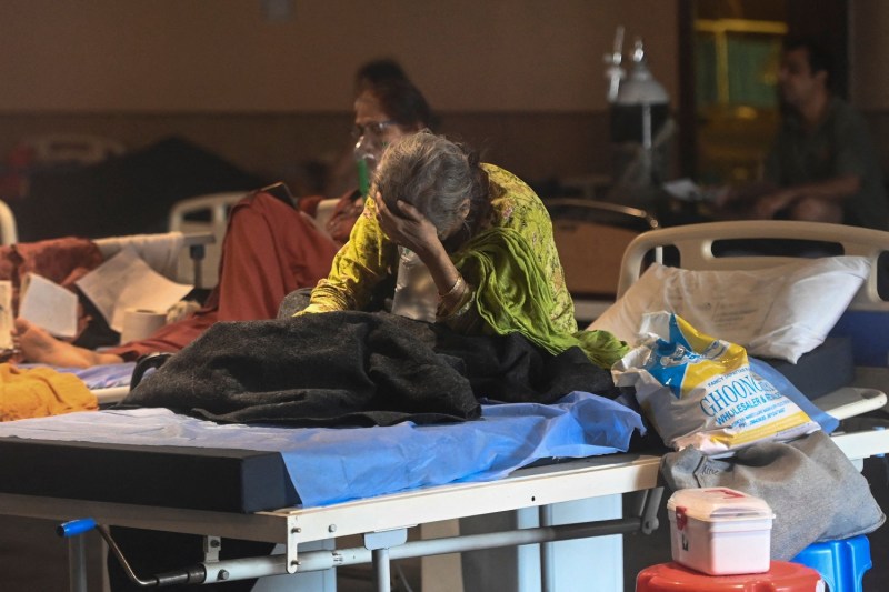 A patient rests inside a banquet hall temporarily converted into a COVID-19 ward in New Delhi on April 27.