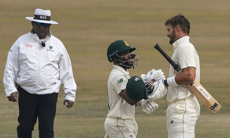 South Africa's Aiden Markram (R) celebrates with teammate Temba Bavuma (C) after scoring a century (100 runs) during the fifth and final day of the second Test cricket match at the Rawalpindi Cricket Stadium on Feb 8. —  AFP