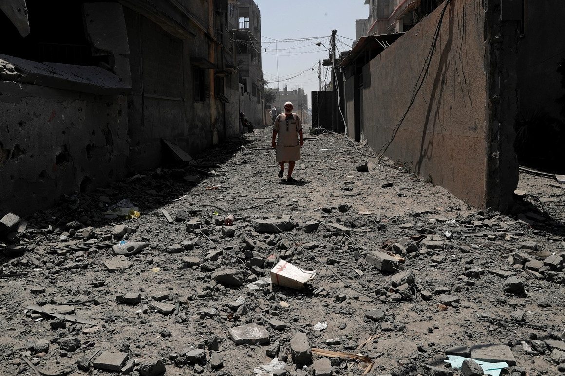 A man walks amid rubble in Gaza City
