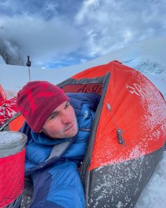 Tomas Petrecek takes a selfie half body out of a tiny bivouaq tent, during the acclimatization phase before attempting Masherbrum.