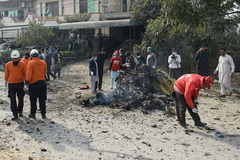 <p>Rescue workers and police officers gather at the site of a suicide car bombing in Islamabad on December 23, 2022.—Reuters/Waseem Khan</p>