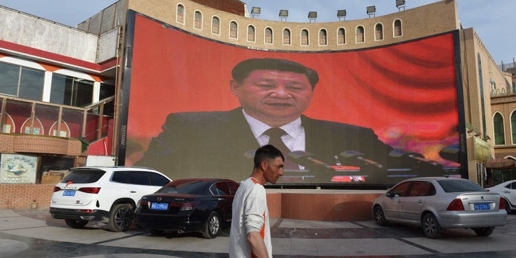 This photo taken on June 4, 2019 shows a man walking past a screen showing images of China's President Xi Jinping in Kashgar in China's northwest Xinjiang region. - China has enforced a massive security crackdown in Xinjiang, where more than one million ethnic Uighurs and other mostly Muslim minorities are believed to be held in a network of internment camps that Beijing describes as vocational education centres aimed at steering people away from religious extremism. (Photo by Greg Baker / AFP) (Photo credit should read GREG BAKER/AFP via Getty Images)'s President Xi Jinping in Kashgar in China's northwest Xinjiang region. - China has enforced a massive security crackdown in Xinjiang, where more than one million ethnic Uighurs and other mostly Muslim minorities are believed to be held in a network of internment camps that Beijing describes as vocational education centres aimed at steering people away from religious extremism. (Photo by Greg Baker / AFP) (Photo credit should read GREG BAKER/AFP via Getty Images)