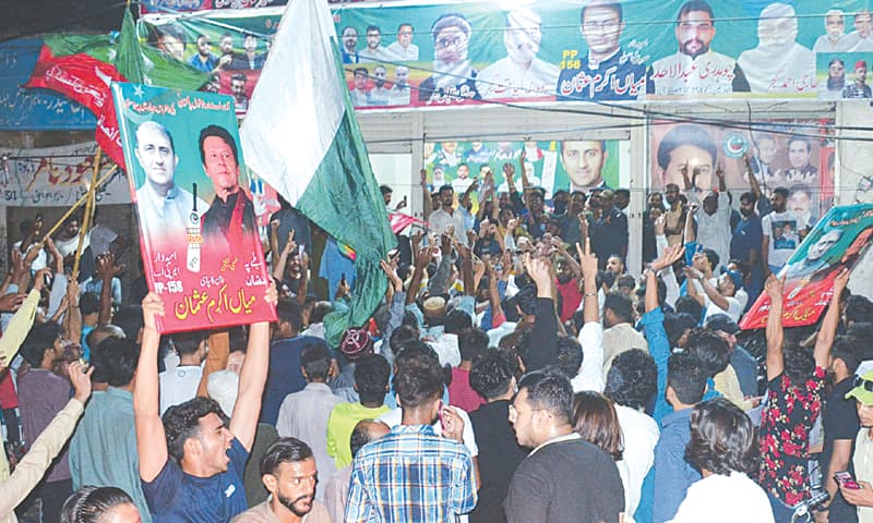 PTI workers celebrate the victory at a party office in Lahore.—Arif Ali / White Star