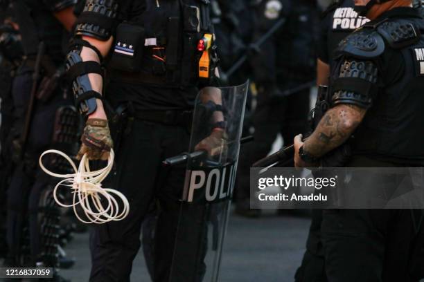 a-washington-d-c-metropolitan-police-officer-holds-plastic-handcuffs-before-arresting-protes.jpg