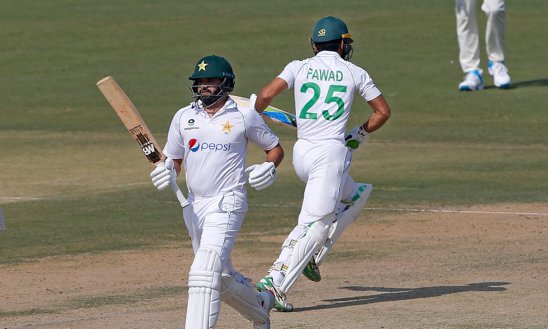 Azhar Ali, front, and Fawad Alam run between the wickets during the second day of the first Test match between Pakistan and South Africa at the National Stadium, in Karachi on Wednesday, Jan 27. — AP