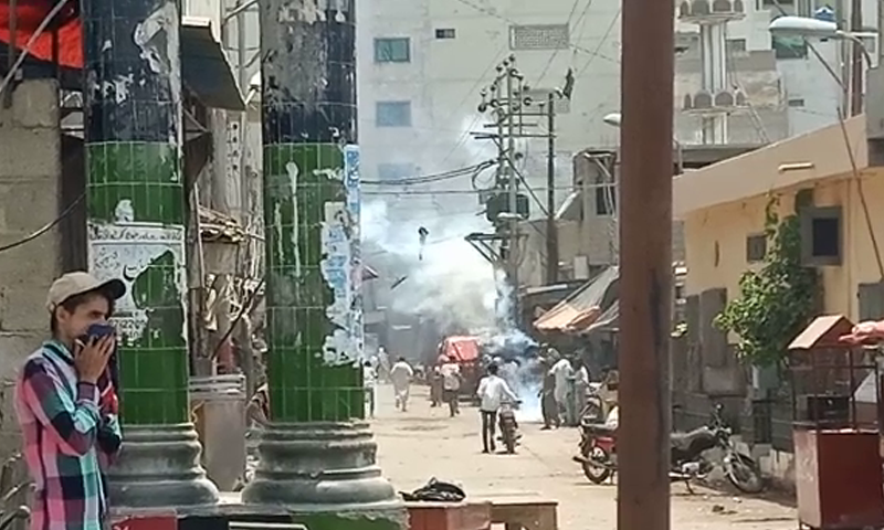 Law enforcers use tear gas against residents of Lyari. — DawnNewsTV