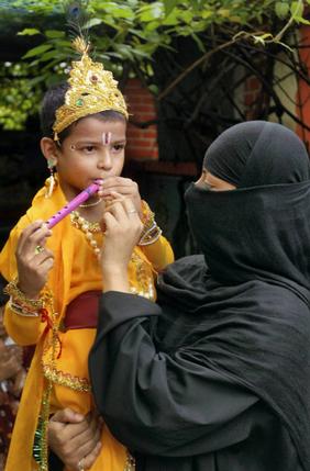 a-muslim-woman-carries-her-son-dressed-as-lord-krishna-on-the-occassion-of-janamashtami-in-patna.jpg