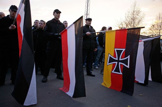 Neo-Nazis+hold+flags+near+a+solider%27s+cemetery