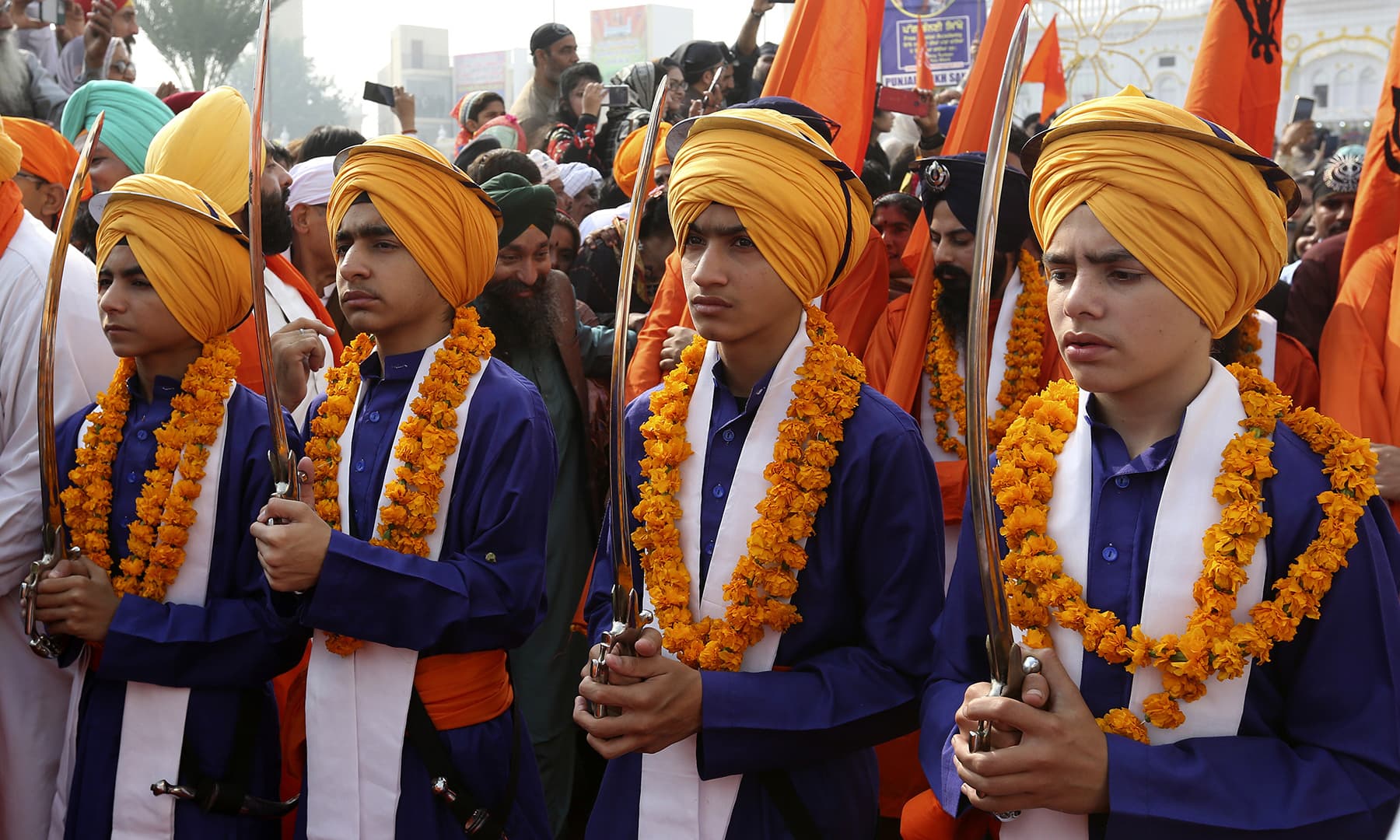 Sikh boys in traditional dress attend a religious ceremony to celebrate the birth anniversary of Baba Guru Nanak Dev in Nankana Sahib. — AP