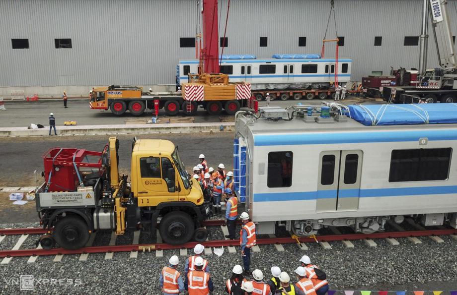 A tractor pushes the first coach forwards to give space for the installing the second coach, that is about to be lifted. From now until the year end, the first train of the metro line would be tested at Long Binh Depot for assessment later.The much-delayed construction began in August 2012, and work is now 76 percent complete. The city hopes to complete 85 percent this year and begin commercial operations by the end of next year.The shipping of the remaining 48 coaches for the line will depending on the pilot run of the first three coaches. If the pilot goes smoothly as expected, more coaches will be delivered in mid next year.