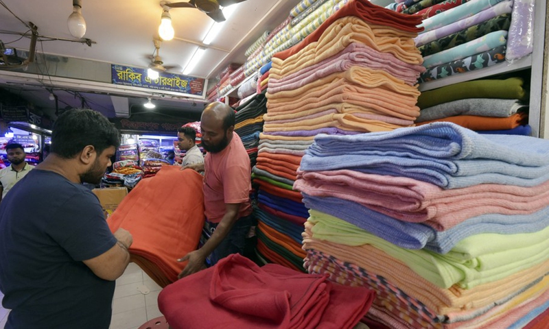 A customer visits a stand selling Chinese blankets at a market in Dhaka, Bangladesh, on Nov. 23, 2022.(Photo: Xinhua)