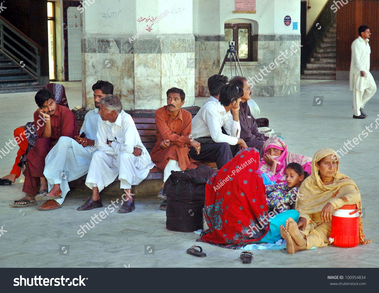 stock-photo-lahore-pakistan-apr-passengers-wait-for-their-trains-at-a-platform-at-lahore-railway-station-100954834.jpg