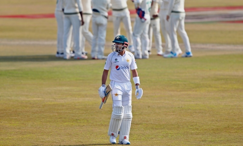 Pakistan's Babar Azam, front, walks back to pavilion while South Africa players celebrate his dismissal during the first day of the second cricket test match between Pakistan and South Africa at the Pindi Stadium in Rawalpindi on Feb 5. — AP
