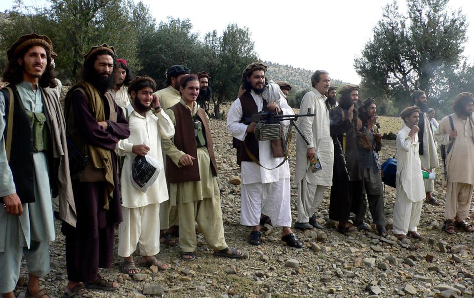 In this image taken on Oct. 4, 2009, Tehreek e Taliban Pakistan leader Hakimullah Mehsud, center, operates light machine gun with his comrades in Sararogha in Pakistani tribal area of South Waziristan along Afghanistan border. Mehsud became the emir of the group in 2009 after its founder, Baitullah Mehsud, was killed in a US drone strike in 2009. Hakimullah Mehsud was killed in 2013 by as US drone strike.