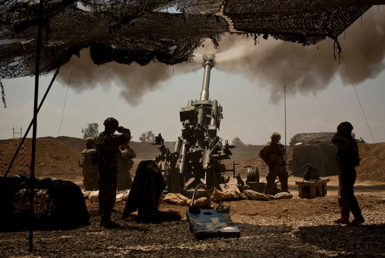 soldiers in shadows firing artillery