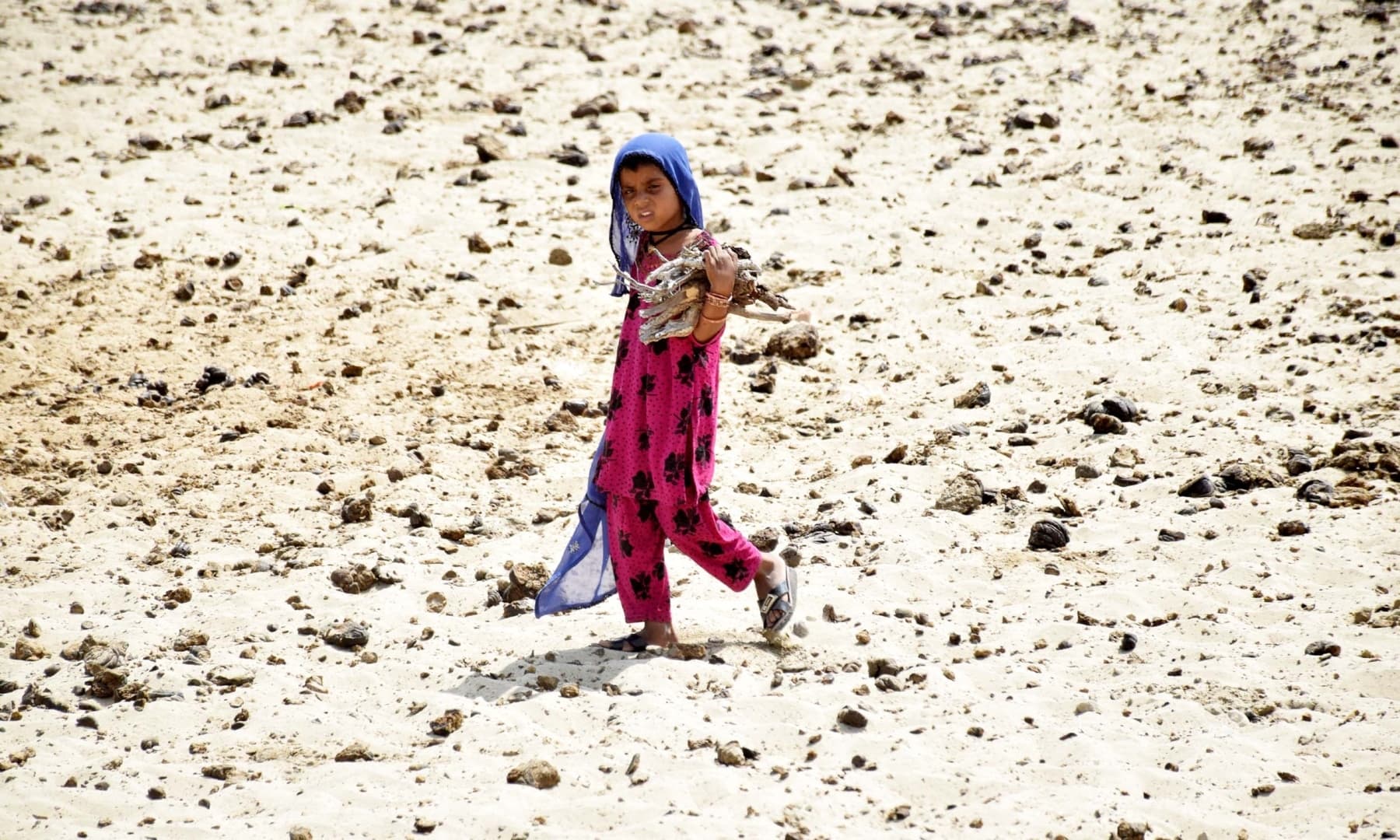 A child walks on barren and arid land in Achhro Thar, Khipro, Sindh. — Photo by Umair Ali