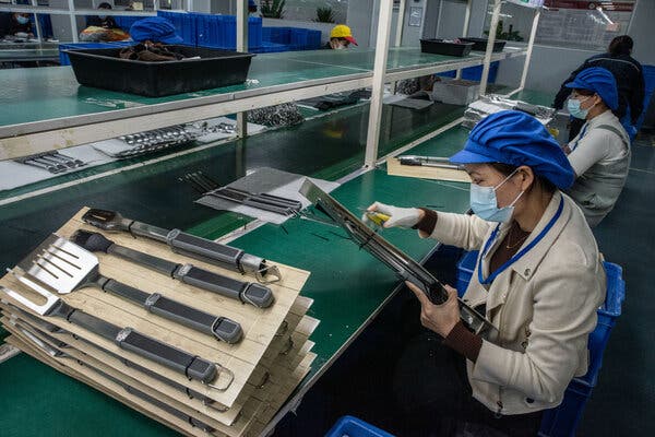 Workers on the packaging line at a factory producing tools and accessories for grills in Yangjiang, China, in January.