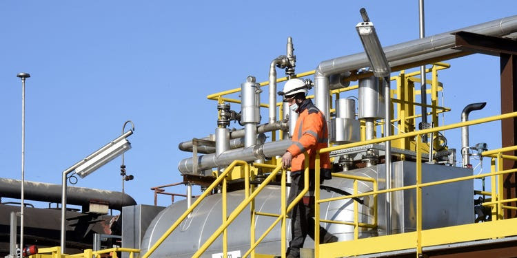 An employee of Arcelor Mittal walks down stairs at a worksite in France.