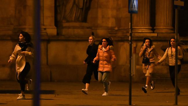 Women run away from the first district near the state opera, central Vienna following a shooting near a synagogue. Picture: AFP