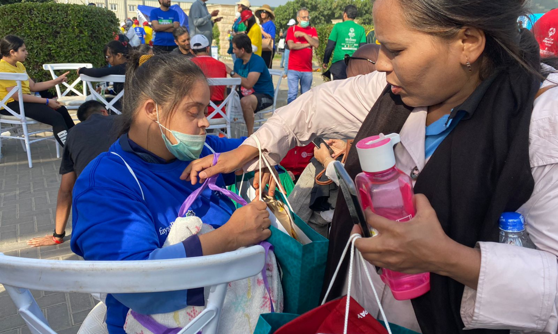 A mother lends a helping hand to her daughter who is seen resting after participating in the 1km Unified Marathon.