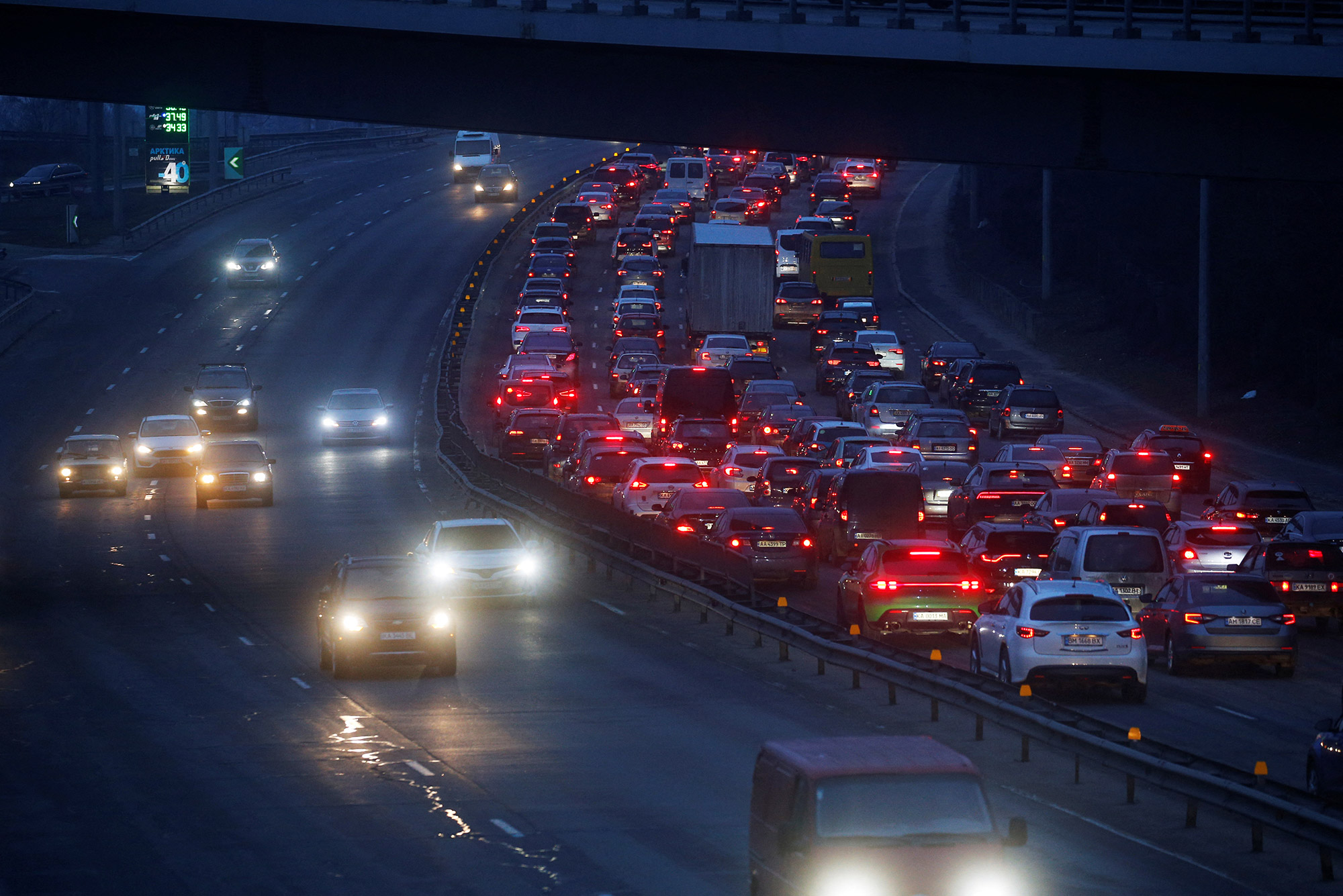 A long line of cars is seen exiting Kyiv on February 24. Heavy traffic appeared to be heading west, away from where explosions were heard early in the morning.