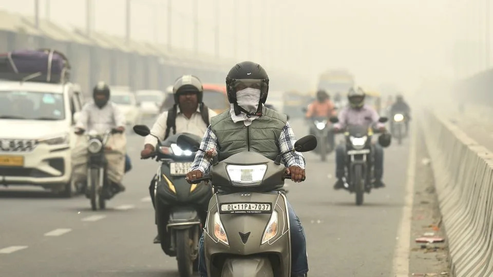 Traffic on a road enveloped by smog in New Delhi, India, on November 3. - AP