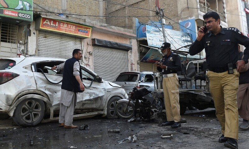 <p>Police officers gather as they survey after a blast in Quetta on April 10. — Reuters</p>