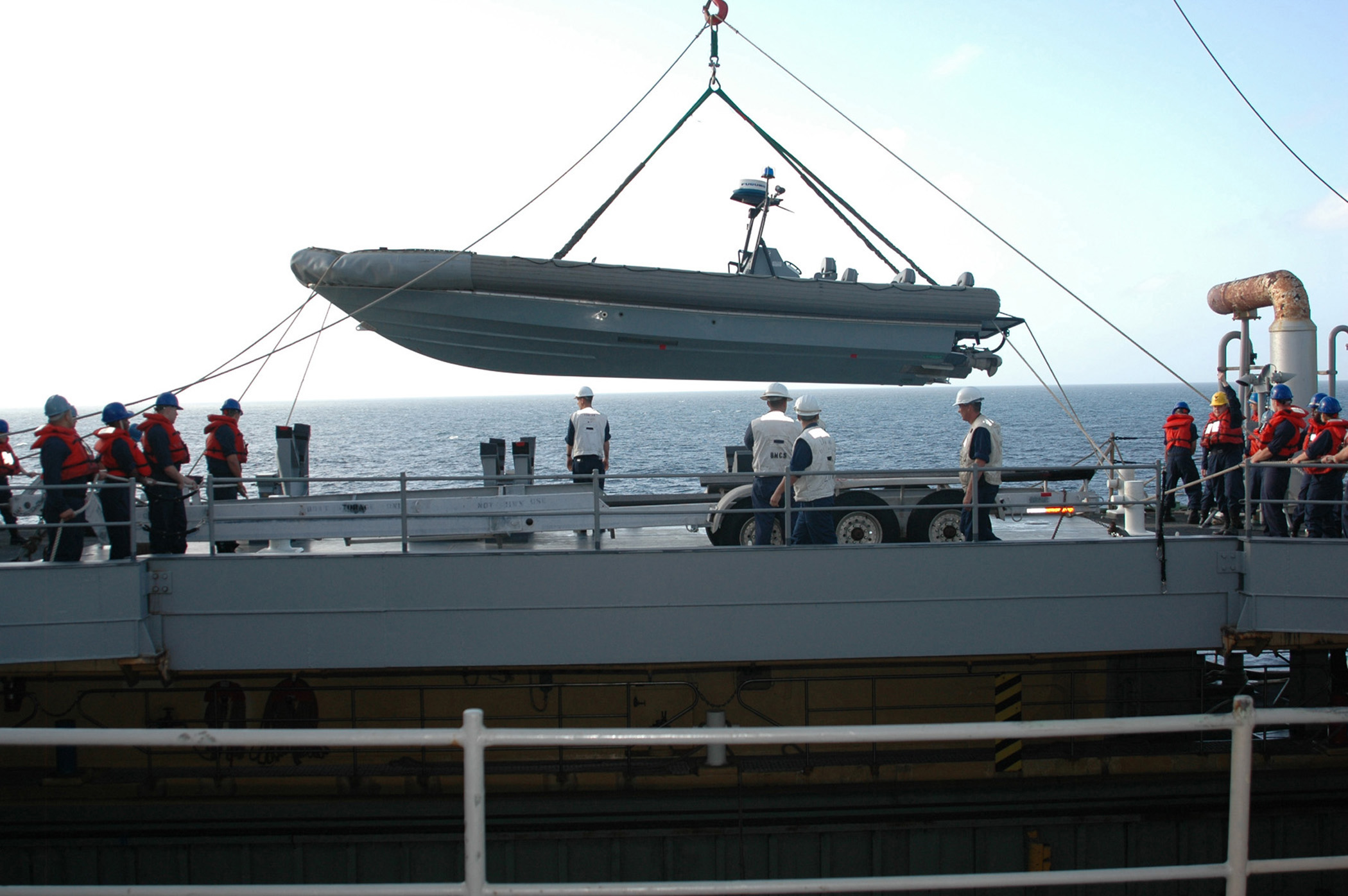 US_Navy_070110-N-1952L-002_Deck_Department_aboard_the_Whidbey_Island-class_dock_landing_ship_USS_Ashland_(LSD_48)_use_a_crane_to_lower_one_of_its_Rigid_Hull_Inflatable_Boats_(RHIB)_into_the_water.jpg