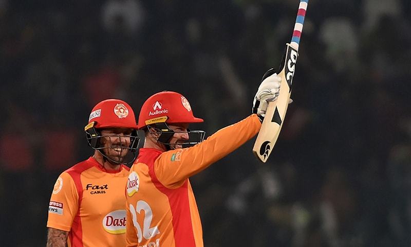 Islamabad United's Colin Munro (R) celebrates after scoring a half century during the PSL T20 cricket match between Lahore Qalandars and Islamabad United at Gaddafi Cricket Stadium on March 4, 2020. — AFP/File