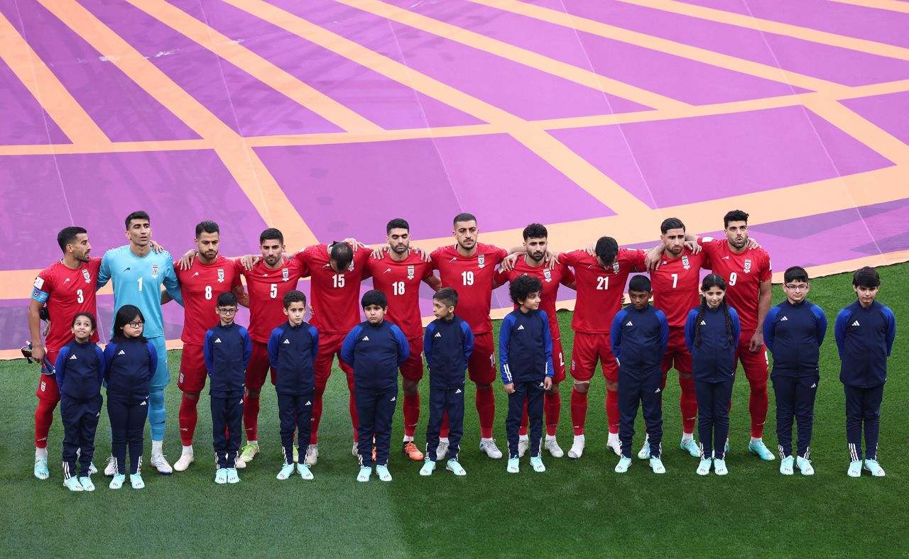 Iranian players line up during the national anthems before the match. <a href=https://www.cnn.com/sport/live-news/world-cup-11-21-22/h_50f93bd8ea9d8fd0dccb42479a5b070e target=_blank>They did not sing</a> during their anthem.