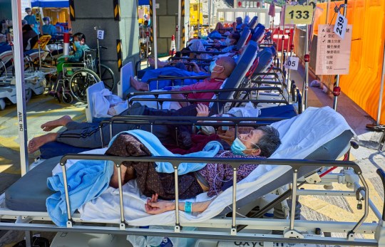 Mandatory Credit: Photo by Emmanuel Serna/SOPA Images/REX/Shutterstock (12828691f) Covid-19 patients seen laying on beds outside the Caritas Medical Center in Hong Kong. Hong Kong hospitals are overwhelmed as the city is facing its worst-ever coronavirus outbreak. Hospitals overwhelmed as covid-19 cases rise in Hong Kong, China - 01 Mar 2022
