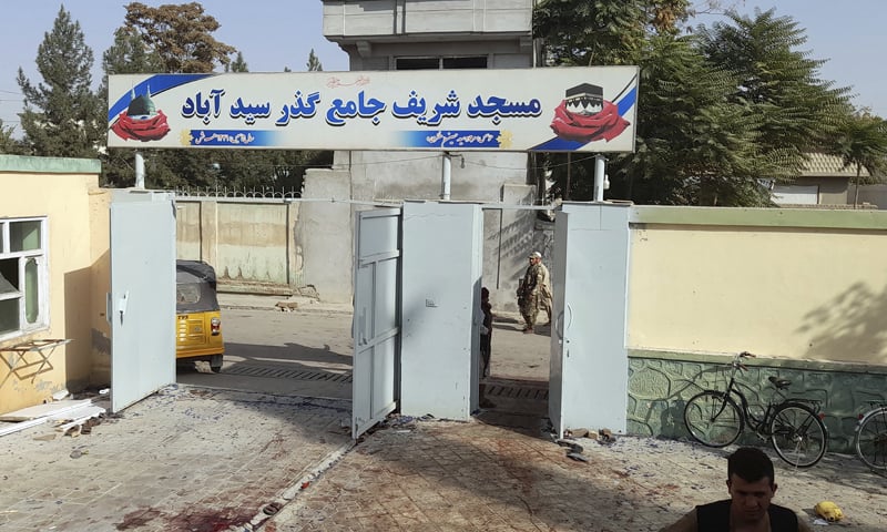 Blood stains are seen outside a mosque after an explosion in Kunduz, Afghanistan. — AP