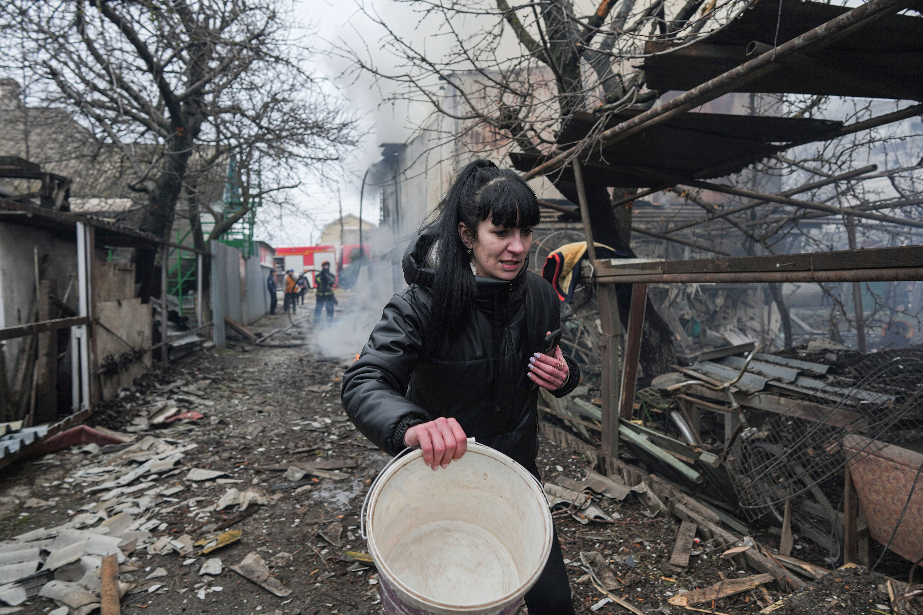A woman walks past debris in the aftermath of shelling in Mariupol, Ukraine, on February 24.
