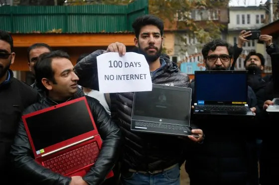 Kashmiri journalists hold placards and protest against 100 days of internet blockade in the region in Srinagar, Indian controlled Kashmir, on Nov. 12, 2019. Internet services have been cut since Aug. 5 when Indian-controlled Kashmir's semi-autonomous status was removed. <span class=copyright>Mukhtar Khan—AP</span>