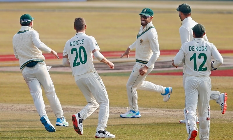South Africa's Faf du Plessis, center, celebrates with teammates after the dismissal of Pakistan's Babar Azam during the first day of the second cricket test match between Pakistan and South Africa at the Pindi Stadium in Rawalpindi on Feb 5. — AP