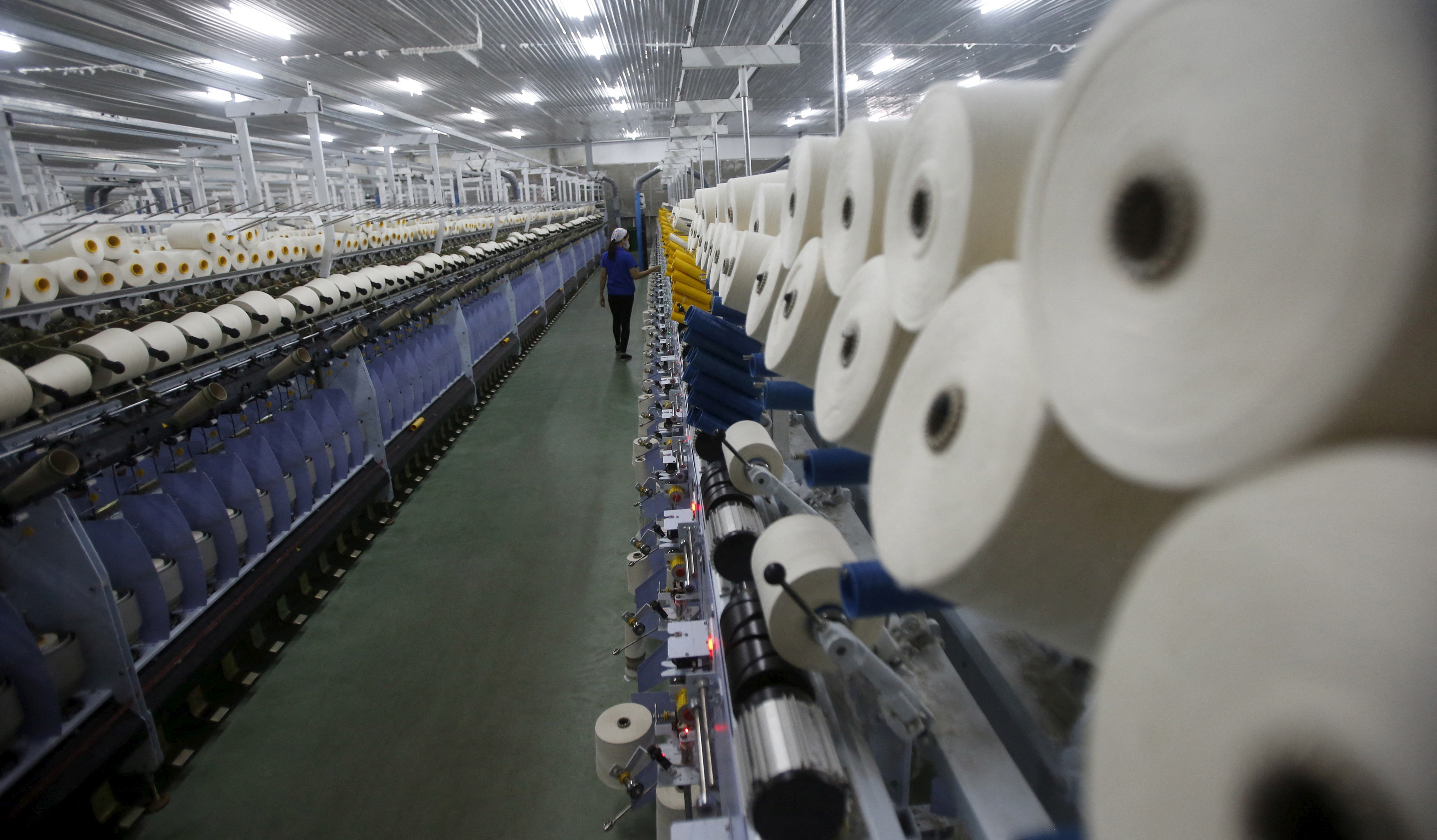 A woman works at a yarn weaving plant in Ha Nam province, outside Hanoi, Vietnam