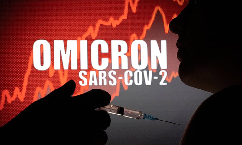 People pose with a syringe with needle in front of displayed words “Omicron Sars-COV-2” in this illustration taken December 11. — Reuters