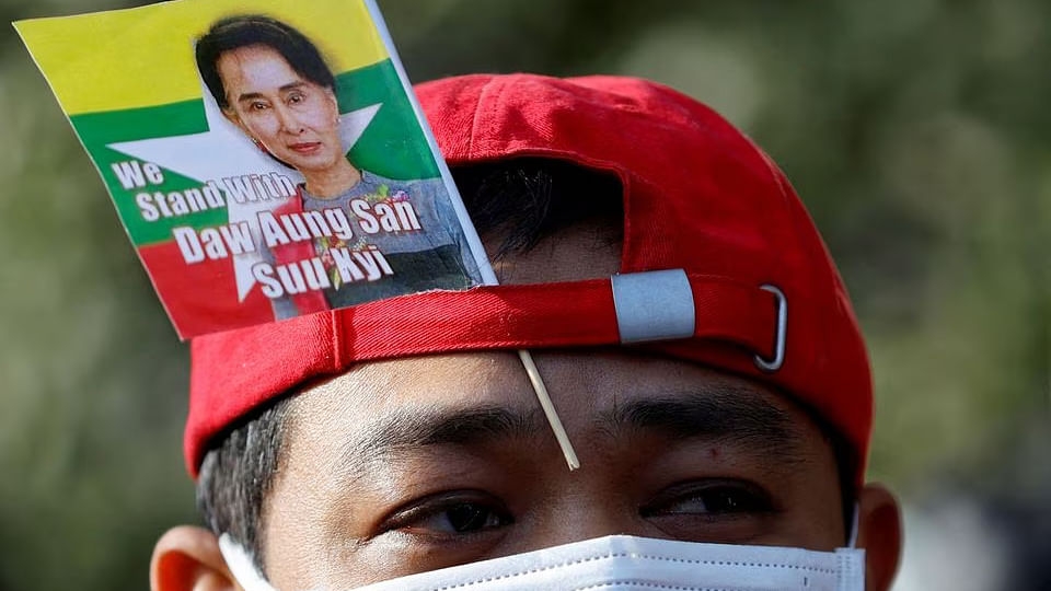 A Myanmar protester residing in Japan uses a flag with an image of deposed Myanmar leader Aung San Suu Kyi during a rally to mark the second anniversary of Myanmar's 2021 military coup, outside the Embassy of Myanmar in Tokyo, Japan on 1 February, 2023