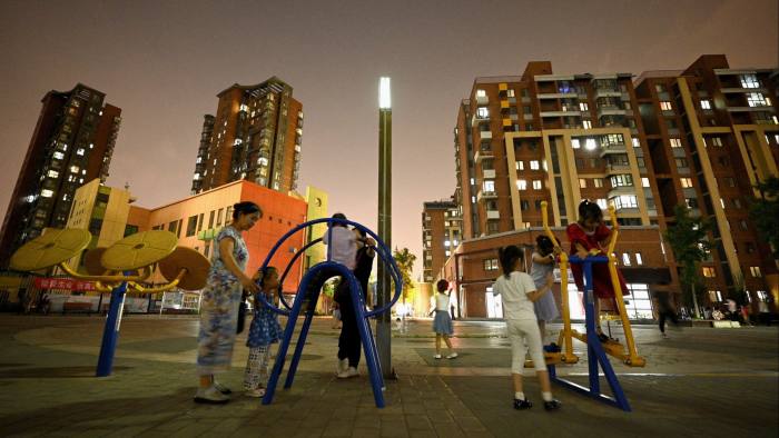 Children playing in front of apartment blocks.