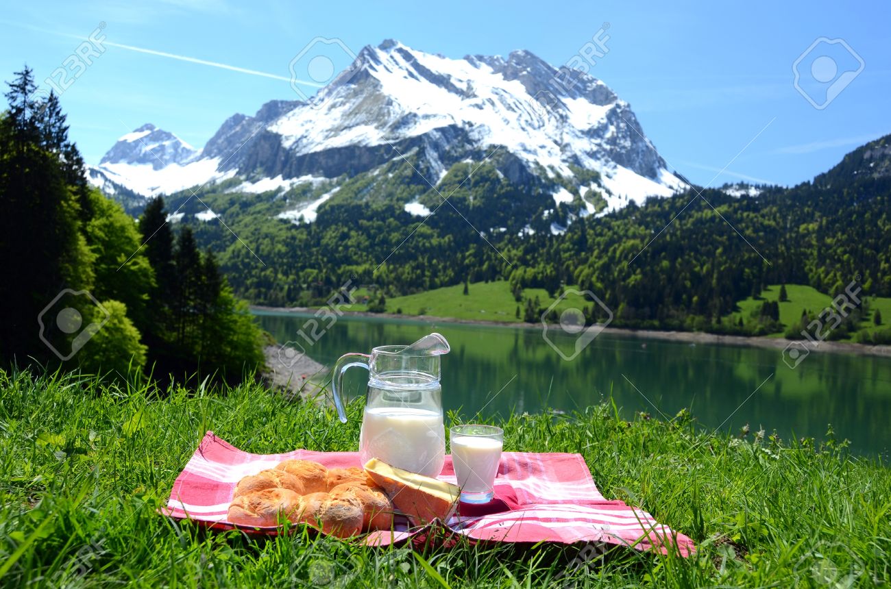 17094725-Milk-cheese-and-bread-served-at-a-picnic-in-an-Alpine-meadow-Switzerland-Stock-Photo.jpg