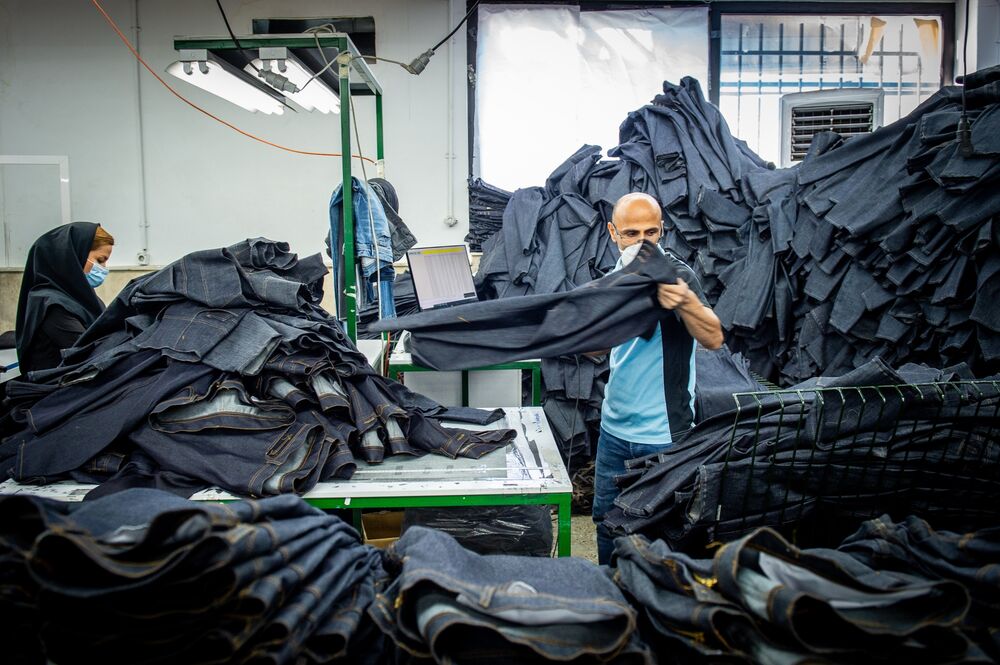 Workers assemble jeans at a clothing factory in the outskirts of Tehran on Oct. 14..