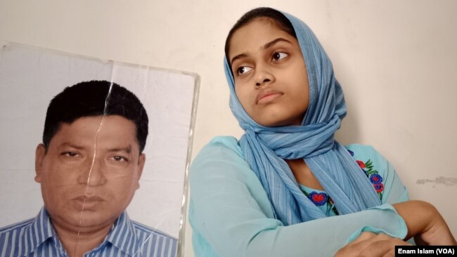Anisha Islam Insha with the photo of her father Ismail Hossain Baten, an enforced disappearance victim. Mr Baten remains has not been seen since members of a government security agency picked him up from Dhaka in 2019. We are anxiously waiting for the safe return of my father, the daughter said.