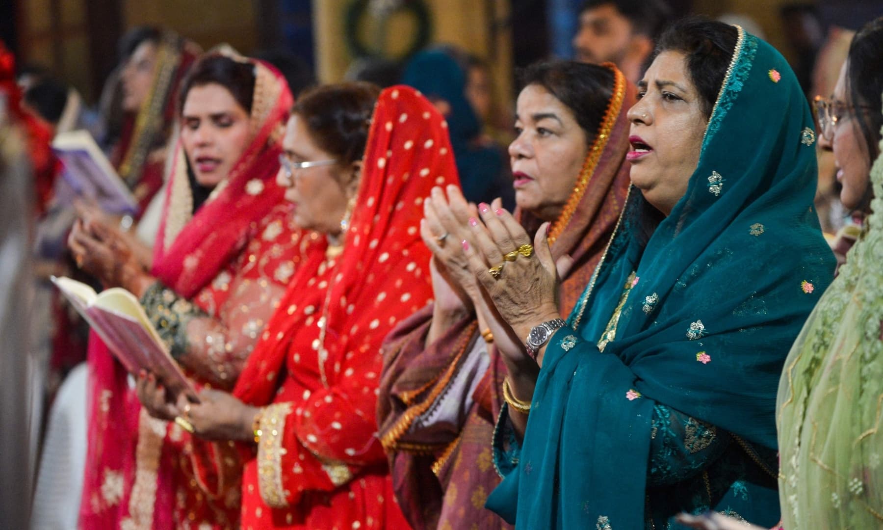 Christian devotees pray at Saint Andrew Church to celebrate Christmas in Karachi on December 24, 2021. — AFP